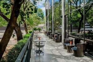 a walkway with tables and chairs in a building at Aloft by Marriott Asuncion in Asunción