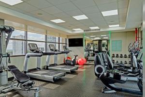 a gym with treadmills and elliptical machines at Aloft by Marriott Asuncion in Asunción