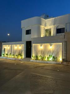 a white building with lights on the side of it at ovation Studio in Riyadh