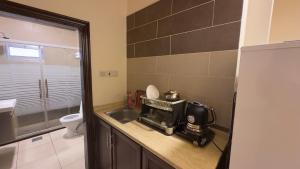a small bathroom with a sink and a toilet at Al Riyati Hotel Apartments in Aqaba +39 photos