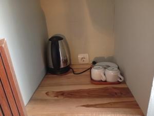 a room with a coffee maker and a coffee pot on the floor at Hepy Hotel in Kuta Lombok