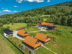 an aerial view of a house with orange roofs at U Pana Boga za piecem - domki w górach, Sauna, Beskidy, Koszarawa in Korbielów