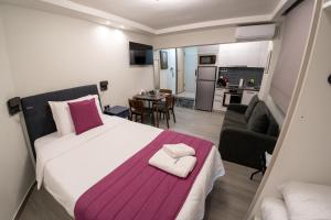a bedroom with a large bed and a living room at Pyrgiou suites in Thessaloniki +102 photos