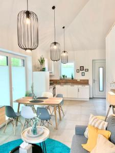 a kitchen and living room with a table and chairs at Idyllisches Ferienhaus mit Spielzimmer und Garten in Sehestedt +13 photos