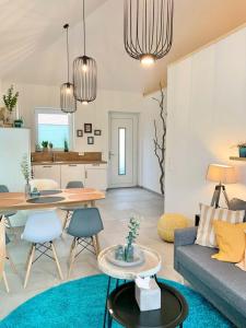 a living room with a couch and a table at Idyllisches Ferienhaus mit Spielzimmer und Garten in Sehestedt