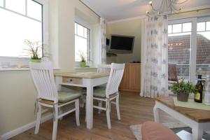 a dining room with a table and two chairs at Wodan, Whg 2 in Tinnum