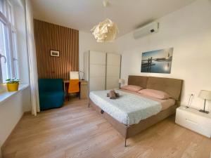 a bedroom with a bed and a desk in it at Residence Neverin Luxury Apartments-Private Garage in Trieste