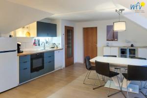 a kitchen with a table and chairs in a room at Kirchstr 38 Borkum Ferienwohnung 38 in Borkum