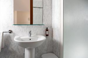 a bathroom with a sink and a toilet and a mirror at Hotel Boccaccio in Florence +41 photos