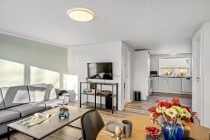 a living room with a couch and a table at FeWo Vidstrup Have in Vidstrup