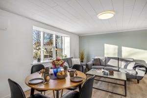 a living room with a table and chairs and a couch at FeWo Vidstrup Have in Vidstrup