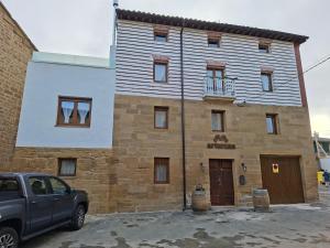 a building with a car parked in front of it at Arturana turismo in Ollauri
