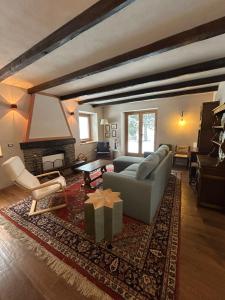 ein Wohnzimmer mit Sofa und Kamin in der Unterkunft Chalet Angelo in Ponte di Legno