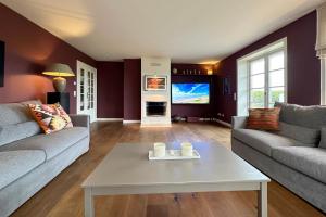 a living room with two couches and a table at Ferienhaus Fiete in Tinnum +42 photos