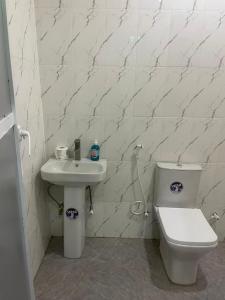a bathroom with a toilet and a sink at Apartment 67 in Akinyele