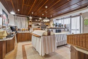 a restaurant with wooden ceilings and a kitchen with tables at White House in Prague