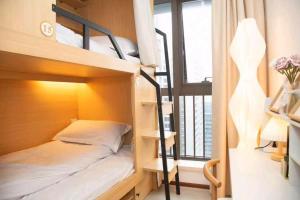 a bedroom with bunk beds and a balcony at Happy Hours in Shenzhen +12 photos