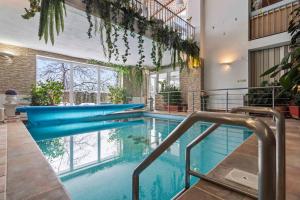 an indoor pool with blue water in a building at White House in Prague