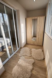 a room with two rugs on the floor next to a door at Urban Apart in Stara Zagora