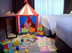 a bedroom with a toy tent and toys on the floor at Ayathorn Bangkok in Bangkok +77 photos