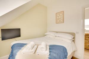 a bedroom with a bed with two towels on it at Apt 3 Armatage Flats, Eyemouth in Eyemouth