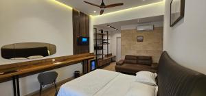 a bedroom with a bed and a mirror and a couch at Resort Comfort - Long Beach in Ulcinj
