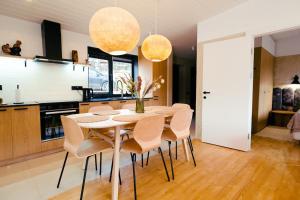 a kitchen and dining room with a table and chairs at Ґонт - затишний будинок з чаном біля Буковелю in Tatariv