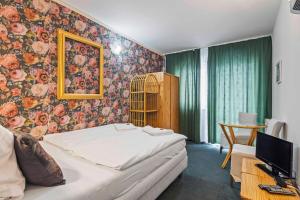 a bedroom with a bed and a tv in a room at White House in Prague