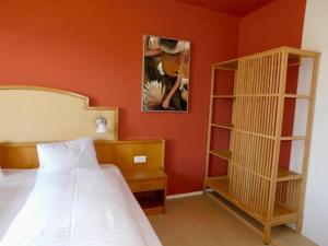 a bedroom with a bed and a book shelf at OhneTamTam in Ehrenhausen