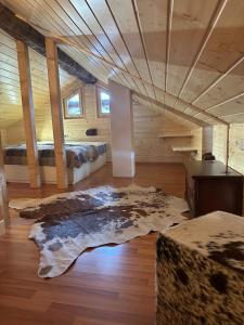 a room with two beds and a rug on the floor at Mayen unique et authentique in Vernamiège