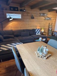 a living room with a table and a couch at Mayen unique et authentique in Vernamiège