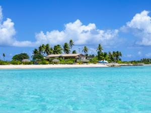 an island in the ocean with a house on it at Hakamanu Lodge in Tikehau