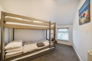a bedroom with two bunk beds and a window at Spacious Three Bedroom Flat in Filey Town Centre with Workspace in Filey