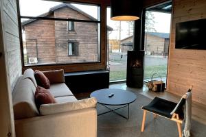 a living room with a couch and a fireplace at Break Sokos Hotel Tykkimäki Resort in Kouvola