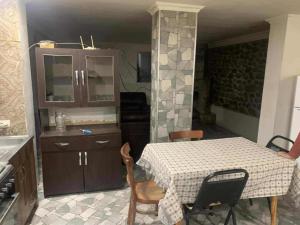 a kitchen with a table and some chairs and a counter at Village house in Telavi