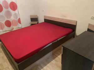 a bedroom with a bed with a red mattress at Village house in Telavi