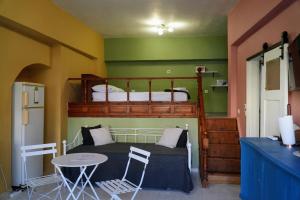 a bedroom with a bunk bed and a table at Symi Central Point in Symi