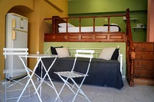 a bedroom with a bunk bed with a table at Symi Central Point in Symi