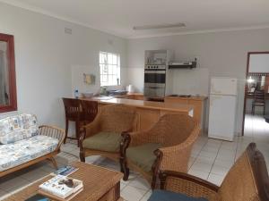 a living room with a couch and a kitchen at Eagles Lodge One in Vosburg