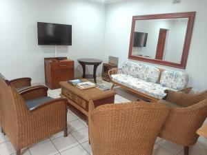 a living room with a couch and chairs and a mirror at Eagles Lodge One in Vosburg