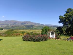 a garden with a arch and flowers in a field at Eagles Lodge One in Vosburg