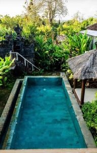 a swimming pool in a villa with a resort at Garden House Balangan in Uluwatu