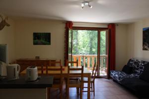 a living room with a table and a couch at Les cerfs in Roubion