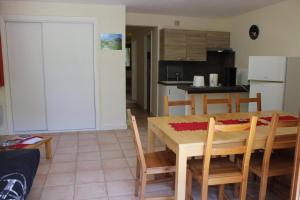 a kitchen and dining room with a table and chairs at Les cerfs in Roubion