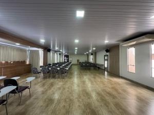 a large room with chairs and tables in it at Luz Hotel Pato Branco in Pato Branco