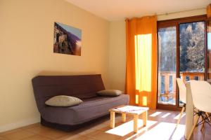 a living room with a couch and a window at Les biches in Roubion +8 photos