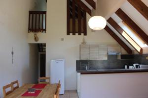 a kitchen with a table and a white refrigerator at Les chamois in Roubion