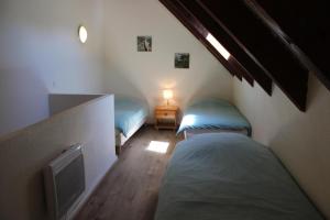a room with two beds and a lamp in it at Les chamois in Roubion