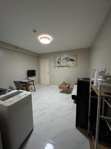 an empty room with a kitchen and a living room at Staycation near MOA at Monarch in Manila