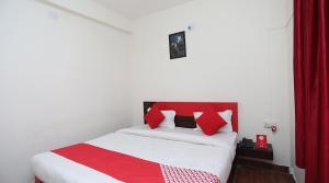 a red and white bed in a small room at Hotel Sintle Palace in Bhubaneshwar +8 photos